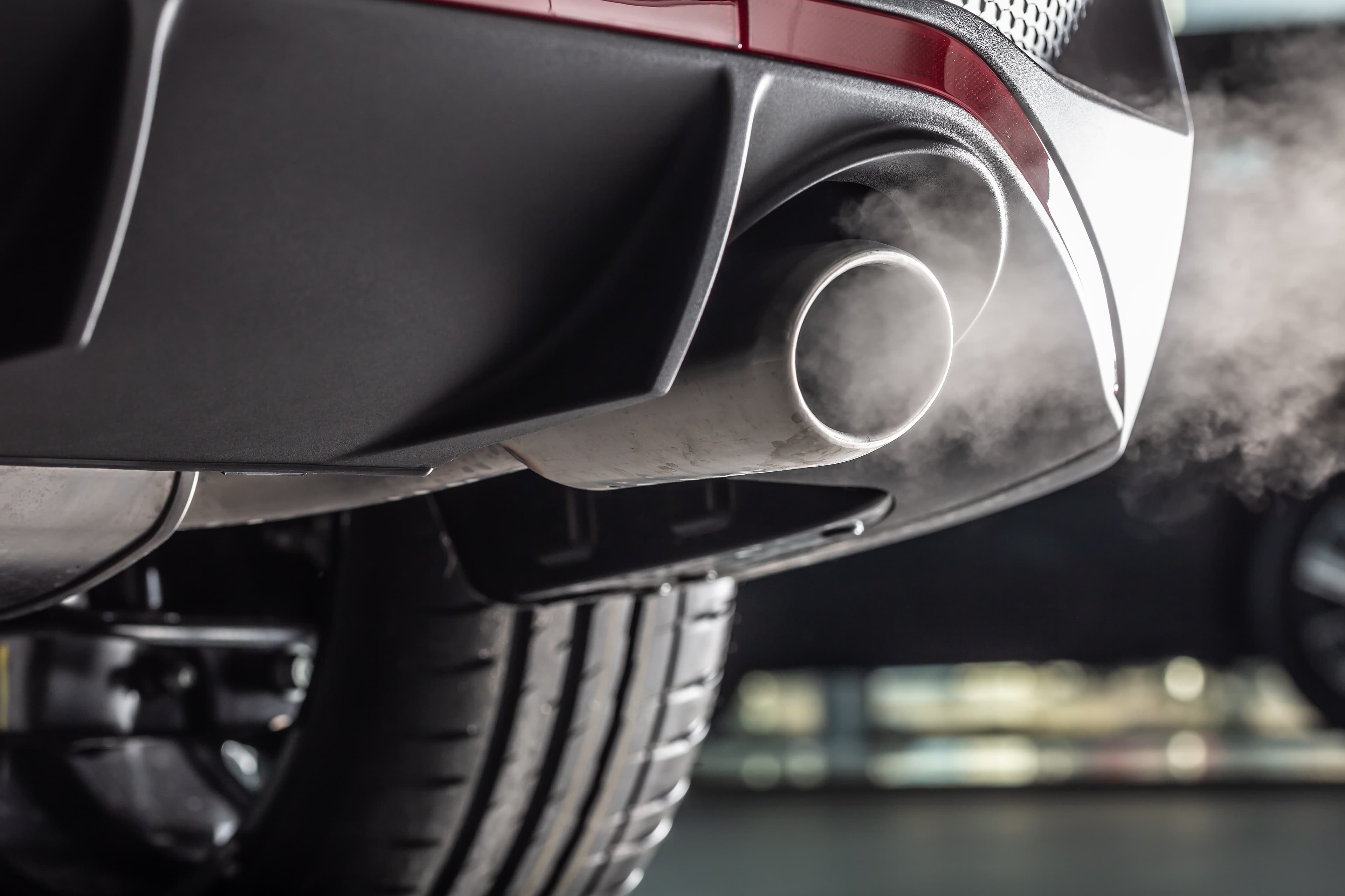 close up of a cars exhaust producing smoke